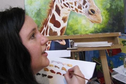 girl painting giraffe